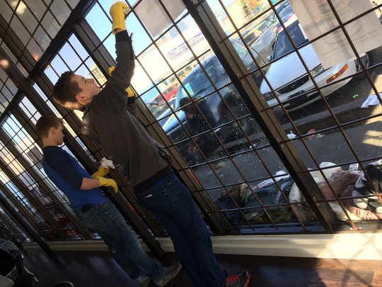 Washing windows at NightShift Street Ministries - note the homeless camped outside